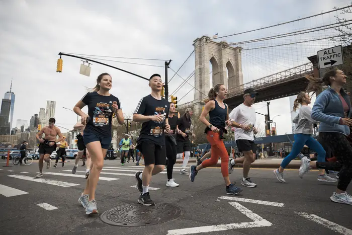 Runners run near the Brooklyn Bridge in a previous NYCRUNS Brooklyn Half Marathon.